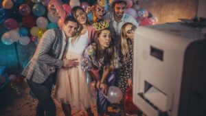 A crowd using a photo booth at an event.