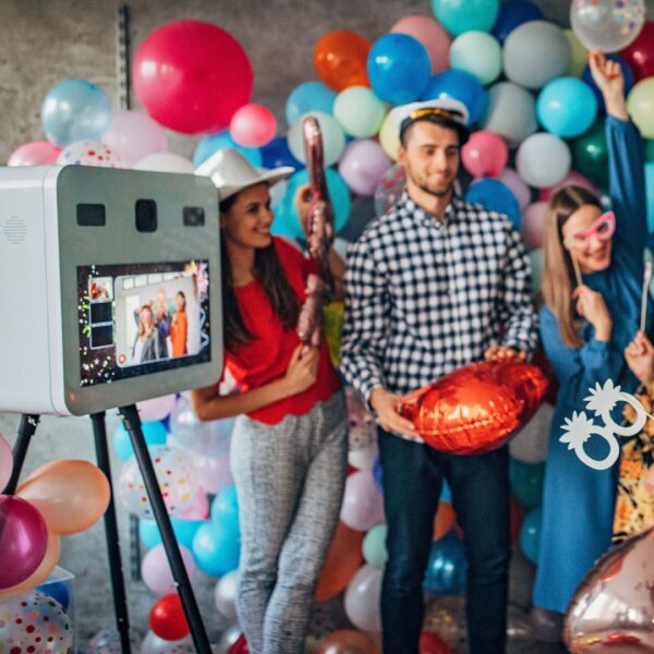 Group celebrating with photo props in front of a photo booth